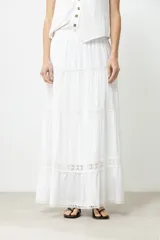 Maxi falda blanca con cintura elastizada y detalles de puntilla.