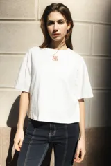 Remera negra de algodón con corte cuadrado, cuello redondo y logo bordado en color naranja.