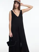 Vestido largo negro de lino, con escote en V, breteles anchos y tajo frontal.