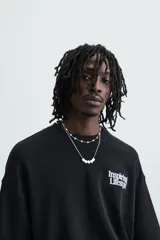 Sudadera negra de algodón con cuello redondo y manga corta. Estampa frontal con la frase "Inspiring Lifestyle" en letras blancas.