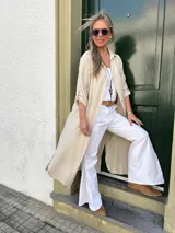 Pantalón blanco de algodón con lycra, estilo sastrero y corte acampanado.
