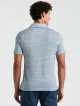 Polo celeste con textura de lino, manga corta, cuello clásico y logo bordado en el pecho.