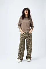 Buzo color marrón de corte relajado confeccionado en tejido de algodón con interior suave al tacto. Presenta detalle de estrella con tachas en la espalda y bordado delantero con la frase Dreamer – Born to rock.