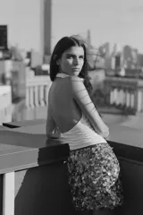 Falda corta de corte recto, completamente cubierta de lentejuelas redondas en tonos plateados y marrones/bronce. Posee forro interior y cierre lateral oculto.