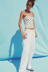 Top blanco con estampado de lunares marrones, corte corsetero, escote corazón y tirantes finos ajustables.