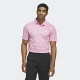Chomba de golf Adidas color rosa con estampado de rombos y logo blanco en el pecho.