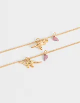 Set de dos collares dorados para compartir, con dije metálico de dinosaurio y corazón imantado.