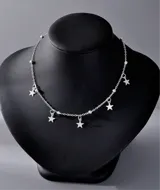 Collar plateado con cadena de eslabones y dijes colgantes de estrellas.