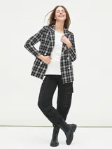 Blazer negro con estampado a cuadros blancos, doble botonadura y solapas de muesca.