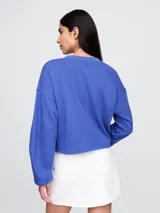 Buzo canguro negro de algodón sin felpa, con cuello redondo y logo Gap bordado en blanco en el frente.