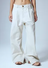 Pantalón de gabardina color crudo, estilo sastrero, de tiro bajo y corte recto. Presenta pinzas delanteras, presillas anchas, tajo interno en la botamanga y badana de PU en la cintura trasera.