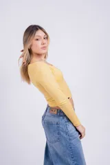 Remera corta de tejido de punto acanalado color fucsia, con escote cuadrado y mangas largas.