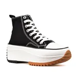 Zapatillas deportivas de caña alta color blanco con suela gruesa de goma color caramelo y detalles en negro.