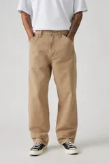 Pantalón de trabajo color beige, de corte recto y holgado, con bolsillos laterales y traseros.
