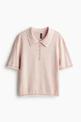 Remera polo de punto fino color rosa pálido con cuello y borde de mangas en blanco.