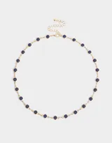 Collar corto dorado con cadena de eslabones y dijes de ojos turcos azules.