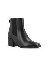 Bota de caña media con estampado de piel de serpiente en tonos marrones, con elásticos laterales negros y taco de madera.