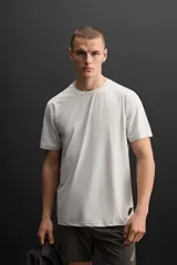 Camiseta deportiva marrón de tejido técnico ligero y elástico con estructura. Cuello redondo, manga corta, costuras planas y logo estampado.
