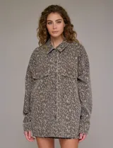Chaqueta de jean oversize con estampado animal print, cuello solapa, abertura central con botones metálicos y bolsillos delanteros.