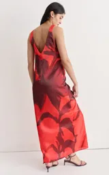 Vestido largo de seda con estampado floral abstracto en blanco sobre fondo negro, escote redondo y corte recto.