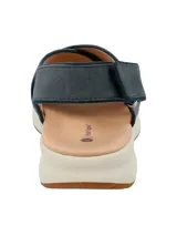 Sandalias de cuero azul con tiras cruzadas y ajuste con velcro en el tobillo. Suela de goma blanca con plantilla color piel.