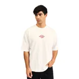 Remera blanca de algodón con estampado pequeño en el pecho de un logo con forma de rombo que contiene una ola estilizada y el nombre de la marca.