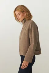 Campera marrón de lana fina, con cuello alto y cierre frontal con cremallera.