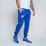 Pantalón de jogging azul marino con puños ajustados, cintura elástica con cordón y bolsillos laterales. Presenta el escudo del Club Nacional de Football y el logo de Umbro.