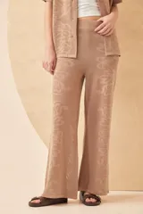 Pantalón de tejido calado color beige, con diseño de corazones y arabescos.
