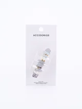 Broche para el pelo con piedras irregulares de color lila, celeste y blanco, unidas por aros dorados.