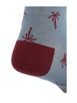 Calcetines largos celestes con diseño de palmeras rojas y puntera y talón en color borgoña.
