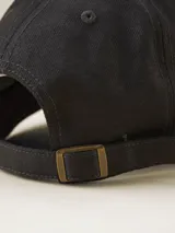 Gorra de gabardina color verde militar con visera curva y logo bordado en el frente. Ajuste trasero con hebilla metálica.