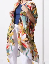 Kimono tejido con estampado abstracto multicolor, mangas amplias estilo japonés y terminación de ruedo con borlas amarillas.