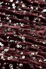 Vestido corto de terciopelo color marrón oscuro con escote redondo, tirantes anchos y detalle de abalorios plateados.
