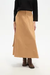 Falda larga color camel, corte evasé, confeccionada en algodón, con un bolsillo cargo grande en el lateral derecho.