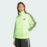 Campera deportiva Adidas Firebird de tejido tricot brillante, color verde lima fluorescente, con cierre frontal y cuello alto. Presenta las tres tiras negras a lo largo de las mangas y el logo del Trifolio negro bordado en el pecho.
