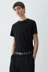 Remera negra de corte ajustado, con cuello redondo ribeteado y bajo recto. Confeccionada con tejido funcional COOLMAX®, una fibra exclusiva de poliéster de secado rápido que elimina la humedad y regula la temperatura corporal.