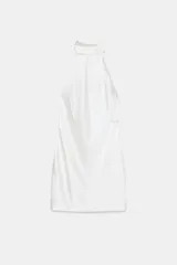 Vestido corto blanco de satén con cuello halter y espalda descubierta.