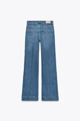 Pantalón de jean de tiro alto con bolsillos frontales y traseros. Corte recto y cierre frontal con cremallera y botón.