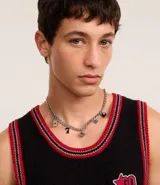 Collar de metal plateado con cadena de eslabones gruesos y dijes colgantes con motivos de casino: dados, cartas, tréboles y número 7.