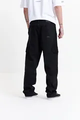 Pantalón cargo color beige, de corte recto, con bolsillos laterales y traseros. Se ajusta a la cintura con cinturón de cuero marrón.