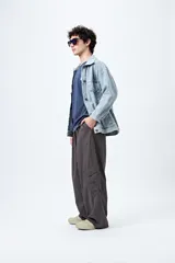 Pantalón cargo color beige, de corte recto y holgado, con cintura elástica y bolsillos laterales con solapa.