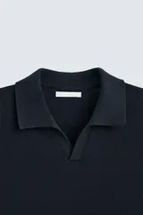 Polo de hombre color azul marino, de punto con textura, cuello solapa con abertura frontal, manga corta y corte regular.