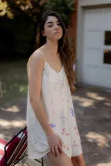 Vestido corto con estampado de cerezas, copas de martini, constelaciones y dados. Tiene breteles finos y espalda con tiras cruzadas.