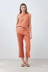 Pantalón celeste de lino, corte recto, con efecto desflecado en el ruedo.