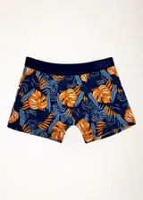 Pack de dos bóxers de largo medio, uno liso color azul y otro estampado con hojas de palmera en tonos naranja y azul. Ambos con elástico visible en la cintura con la marca Prili.
