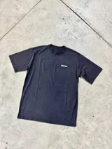 Remera negra de algodón con cuello redondo y calce oversize. Estampado pequeño con el logo de la marca en el pecho.