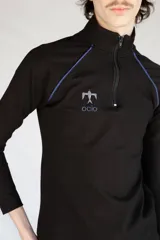 Remera térmica negra de manga larga, confeccionada en jersey de algodón grueso con vivos azules en contraste y logo bordado. Presenta cierre YKK en el cuello.