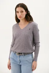 Sweater de punto color gris con escote en V y logo bordado en el pecho.