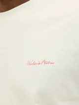 Camiseta color hueso de algodón con estampa fotográfica en la espalda, corte holgado, cuello redondo y mangas cortas.